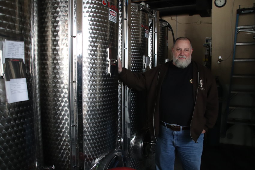 Andy Barnett, owner of Barnett and Son Brewing Co. in Parker, poses for a portrait by the brewing equipment.